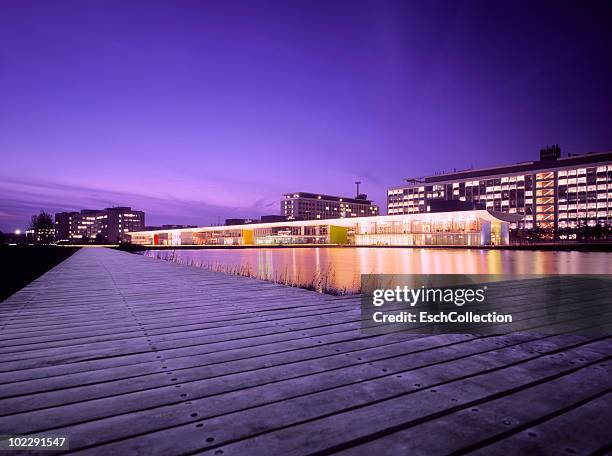 sunset at a modern illuminated business park - eindhoven netherlands stock pictures, royalty-free photos & images