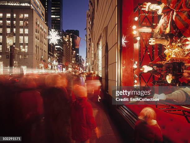 people looking at christmas display in new york. - christmas new york stock-fotos und bilder