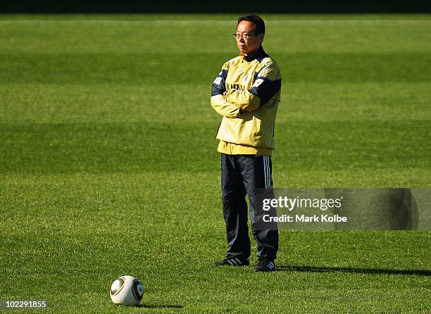 Japan coach Takeshi Okada wqatches on at a Japan training session during the FIFA 2010 World Cup at Outeniqua Stadium on June 22, 2010 in George,...