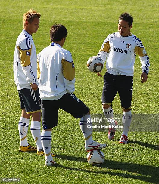 Keisuke Honda, Shinji Okazaki and Yuto Nagatomo wait for the start of a Japan training session during the FIFA 2010 World Cup at Outeniqua Stadium on...