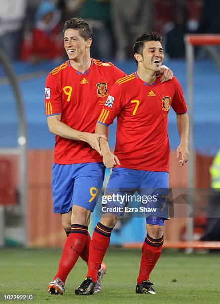 David Villa of Spain celebrates with team mate Fernando Torres after scoring the second goal during the 2010 FIFA World Cup South Africa Group H...