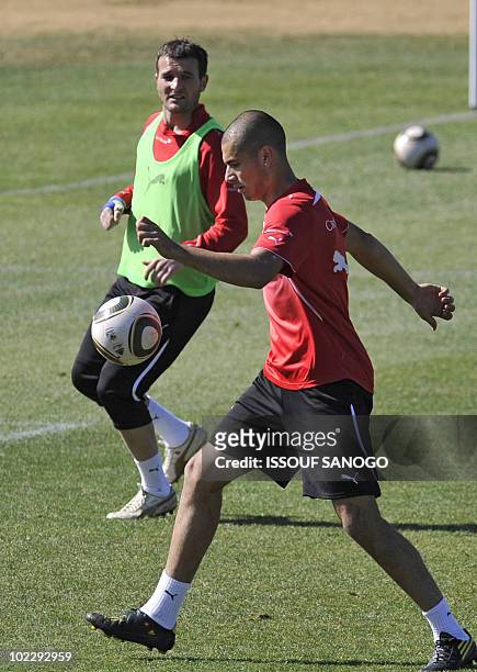 Switzerland's striker Eren Derdiyok is watched by striker Alexander Frei as they take part in a training session on June 22, 2010 at Vaal University...