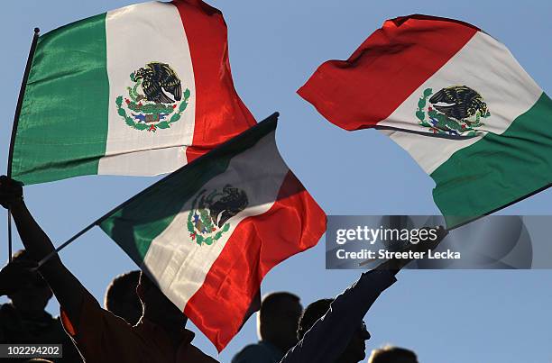 Mexico fans wave flags as they enjoy the atmosphere ahead of the 2010 FIFA World Cup South Africa Group A match between Mexico and Uruguay at the...