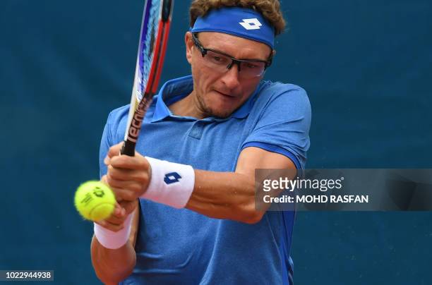 Uzbekistan's Denis Istomin hits a return against China's Wu Yibing during their men's singles final tennis match at the 2018 Asian Games in Palembang...
