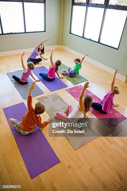 children's yoga class - child yoga elevated view stock pictures, royalty-free photos & images