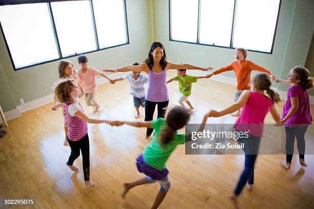 children's yoga class - child yoga elevated view stock pictures, royalty-free photos & images