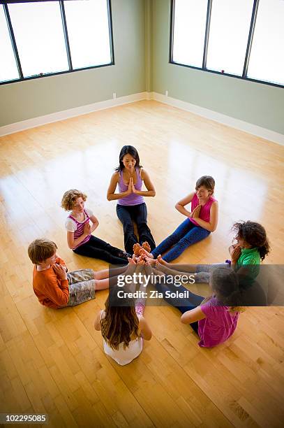 children's yoga class - child yoga elevated view stock pictures, royalty-free photos & images