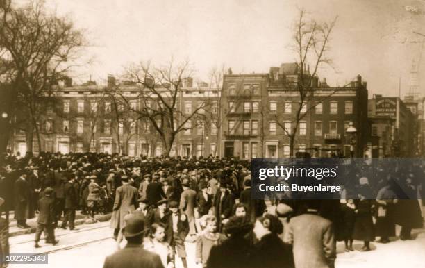 The day after the Triangle Shirtwaist factory fire, crowds gather near the site of the accident, the Asch Building at 23-29 Washington Place, looking...