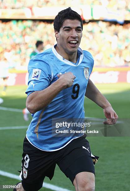 Luis Suarez of Uruguay celebrates scoring the opening goal during the 2010 FIFA World Cup South Africa Group A match between Mexico and Uruguay at...