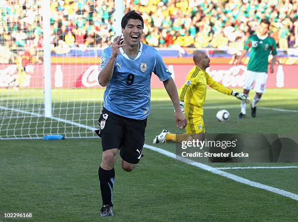 Luis Suarez of Uruguay celebrates scoring the opening goal past Oscar Perez of Mexico during the 2010 FIFA World Cup South Africa Group A match...