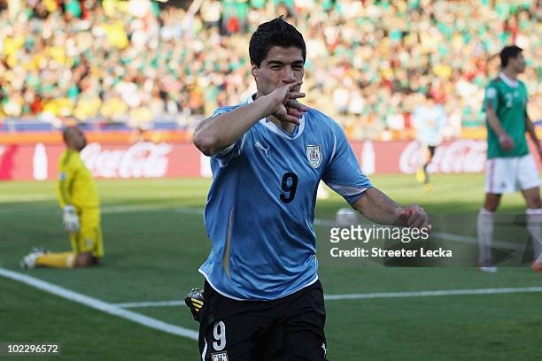 Luis Suarez of Uruguay celebrates scoring the opening goal during the 2010 FIFA World Cup South Africa Group A match between Mexico and Uruguay at...