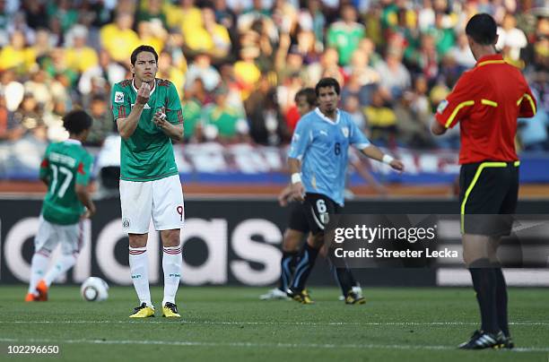 Guillermo Franco of Mexico gestures to referee Viktor Kassai during the 2010 FIFA World Cup South Africa Group A match between Mexico and Uruguay at...