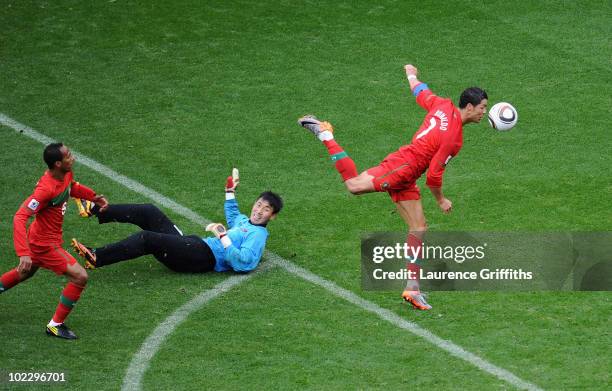 Cristiano Ronaldo of Portugal follows the ball as he scores his team's sixth goal past Ri Myong-Guk of North Korea during the 2010 FIFA World Cup...