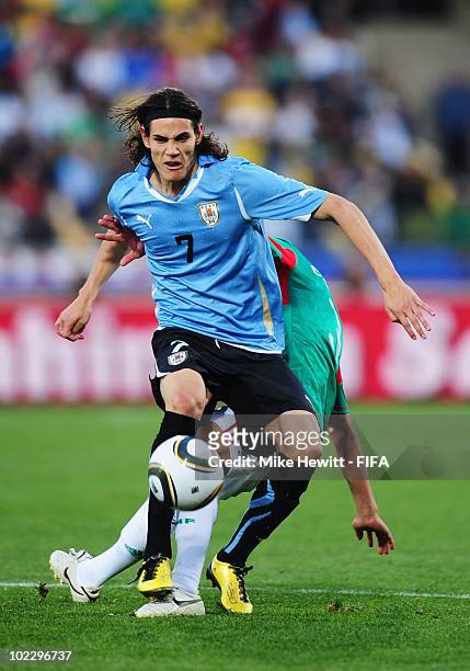 Edinson Cavani of Uruguay is challenged during the 2010 FIFA World Cup South Africa Group A match between Mexico and Uruguay at the Royal Bafokeng...