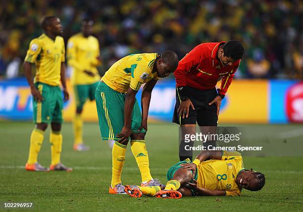 Referee Oscar Ruiz checks on Siphiwe Tshabalala of South Africa during the 2010 FIFA World Cup South Africa Group A match between France and South...