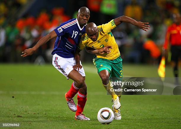 Abou Diaby of France clashes with Tsepo Masilela of South Africa during the 2010 FIFA World Cup South Africa Group A match between France and South...