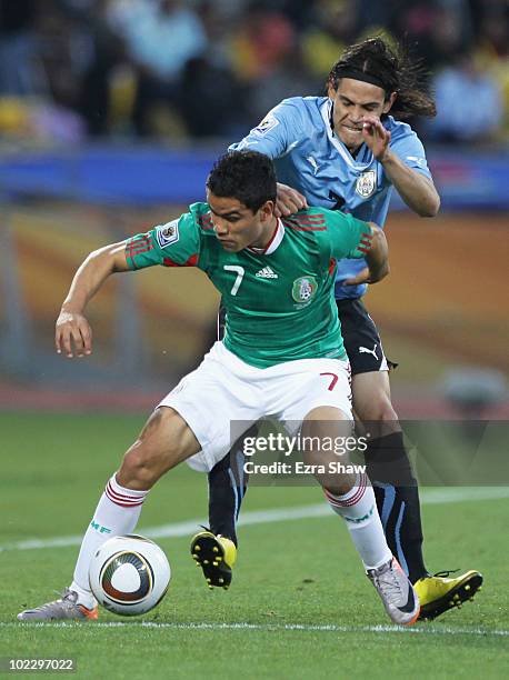 Edinson Cavani of Uruguay and Pablo Barrera of Mexico battle for the ball during the 2010 FIFA World Cup South Africa Group A match between Mexico...