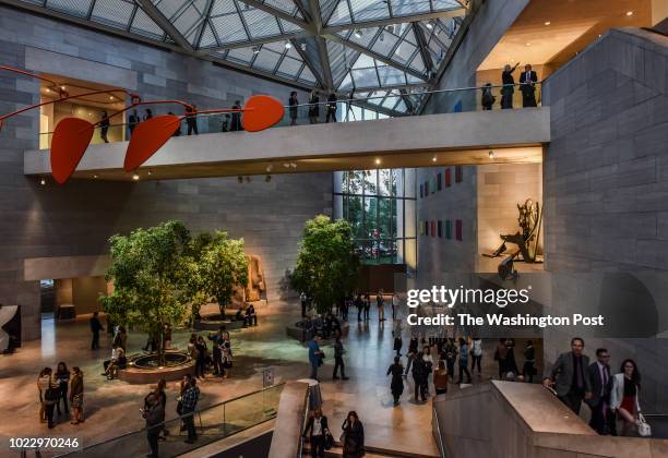 Visitors occupy multiple levels of the atrium during the gallery's first "Evenings at the Edge", an after hours party at the National Gallery of Art...