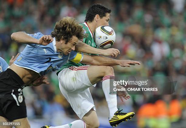 Uruguay's defender Diego Lugano vies with Mexico's striker Guillermo Franco during their Group A first round 2010 World Cup football match on June...