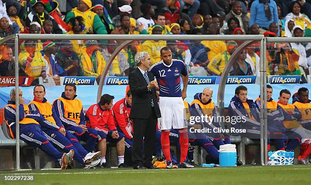 Raymond Domenech head coach of France brings on Thierry Henry as a substitute during the 2010 FIFA World Cup South Africa Group A match between...