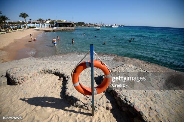 Tourists sunbathe at a beach in Egypt's Red Sea resort town of Hurghada on August 25, 2018.