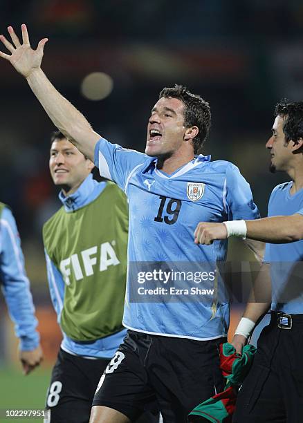 Andres Scotti of Uruguay celebrates victory with team mates after the 2010 FIFA World Cup South Africa Group A match between Mexico and Uruguay at...