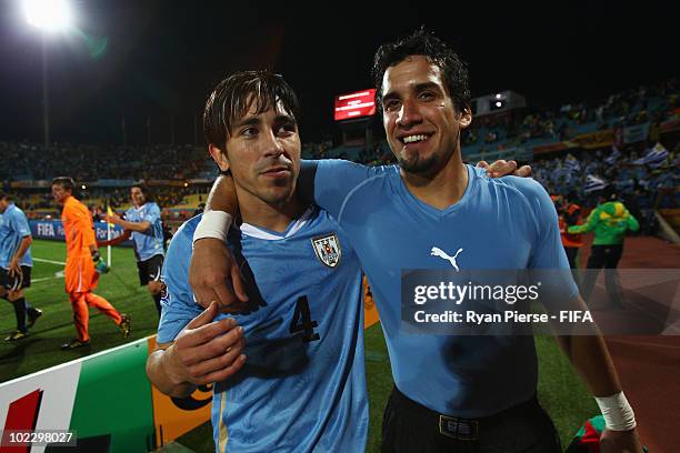 Mauricio Victorino and Jorge Fucile of Uruguay celebrate after the 2010 FIFA World Cup South Africa Group A match between Mexico and Uruguay at the...