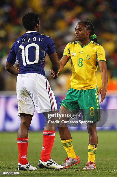 Sidney Govou of France congrautulates Siphiwe Tshabalala of South Africa who looks dejected, as South Africa win their match but leave the...