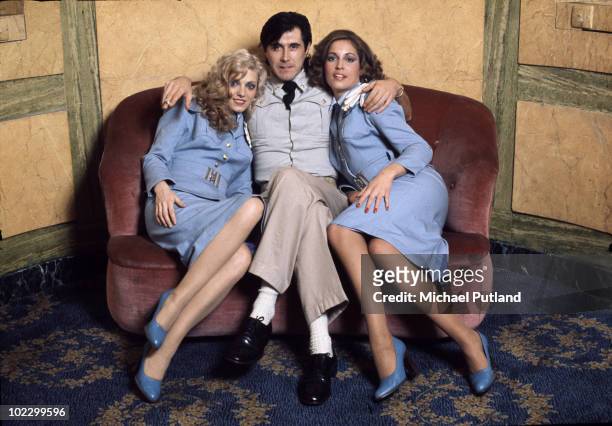 English singer Bryan Ferry with Roxy Music vocalists Doreen Chanter and Jacqui Sullivan, at the Montcalm Hotel, London, 31st October 1975. The ladies...