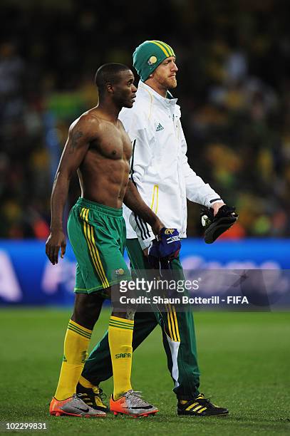 Bongani Khumalo of South Africa and Matthew Booth leave the field after the 2010 FIFA World Cup South Africa Group A match between France and South...