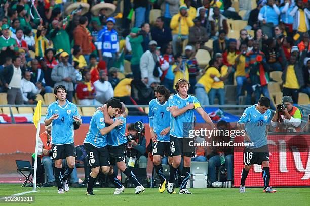 Players of Uruguay celebrate a scored goal by Luis Suarez during a Group A match of 2010 FIFA World Cup against Mexico at the Royal Bafokeng stadium...