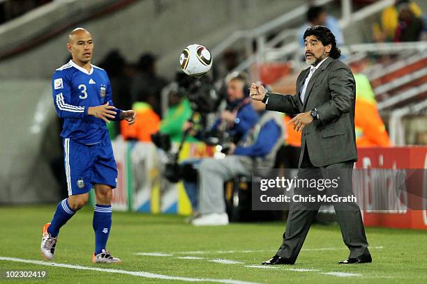 Diego Maradona head coach of Argentina instructs his players from the touchline during the 2010 FIFA World Cup South Africa Group B match between...