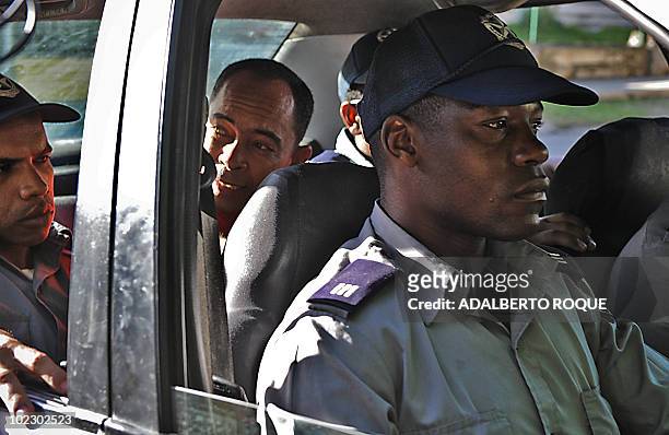 Cuban regime opponent, doctor Darsi Ferrer , is seen inside a police car, on June 22 upon his arrival at the court in Havana. Ferrer had been...