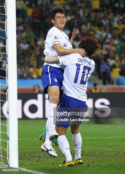 Lee Jung-Soo of South Korea celebrates with team mate Park Chu-Young after scoring the equalising goal during the 2010 FIFA World Cup South Africa...