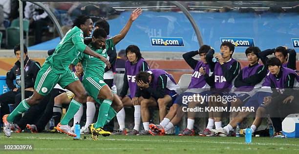 Nigeria's defender Ayodele Adeleye celebrates with midfielder Kalu Uche after the latter scored the team's first goal as South Korean players look on...