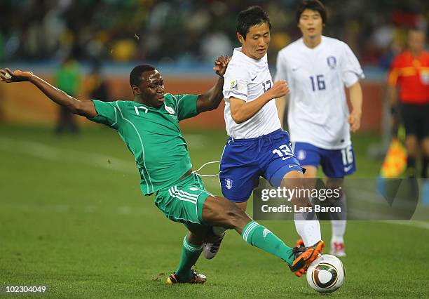 Chinedu Ogbuke Obasi of Nigeria tackles Lee Young-Pyo of South Korea during the 2010 FIFA World Cup South Africa Group B match between Nigeria and...