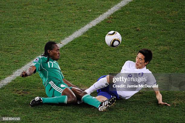 Chidi Odiah of Nigeria and Kim Jung-Woo of South Korea challenge for the ball during the 2010 FIFA World Cup South Africa Group B match between...