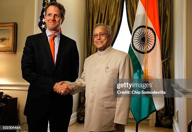 Treasury Secretary Timothy Geithner poses for photographs with Indian Finance Minister Pranab Mukherjee before a meeting at the Treasury Department...