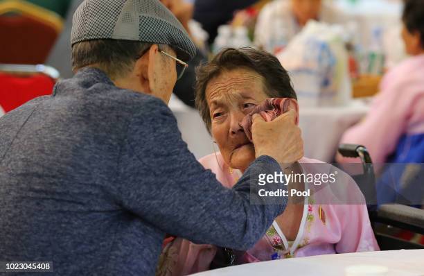 South Korean Choi Sung-Taek, 82 wipes tears of his North Korean sister Ahn Kil-Ja, 85 during a separated family reunion meeting at the Mount Kumgang...