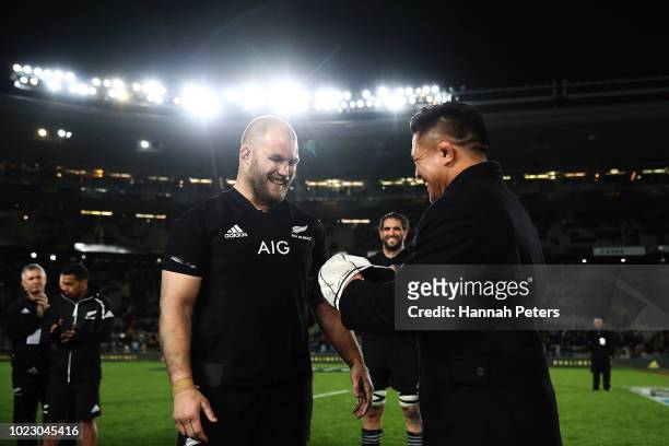 Former All Black Keven Mealamu presents Owen Franks with his cap for playing 100 tests following The Rugby Championship game between the New Zealand...