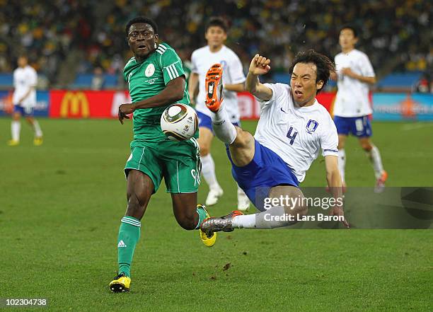 Obafemi Martins of Nigeria is tackled by Cho Yong-Hyung of South Korea during the 2010 FIFA World Cup South Africa Group B match between Nigeria and...