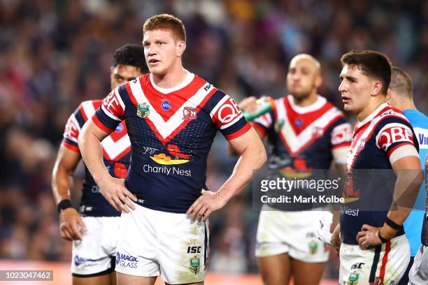 Dylan Napa of the Roosters looks dejected as he watches on during the round 24 NRL match between the Sydney Roosters and the Brisbane Broncos at...