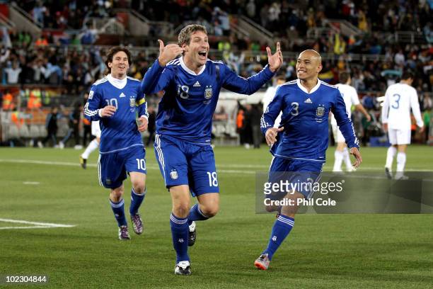 Martin Palermo of Argentina celebrates scoring the second goal with team mates Lionel Messi and Clemente Rodriguez during the 2010 FIFA World Cup...