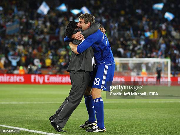 Diego Maradona head coach of Argentina celebrates a goal with Martin Palermo of Argentina during the 2010 FIFA World Cup South Africa Group B match...