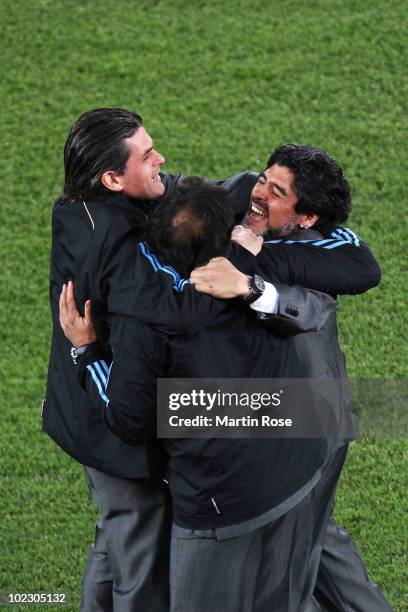 Diego Maradona head coach of Argentina celebrates victory with members of coaching staff after the 2010 FIFA World Cup South Africa Group B match...