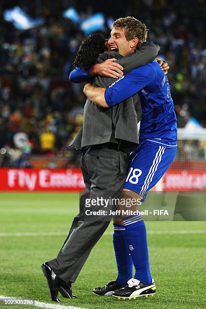 Diego Maradona head coach of Argentina celebrates a goal with Martin Palermo of Argentina during the 2010 FIFA World Cup South Africa Group B match...