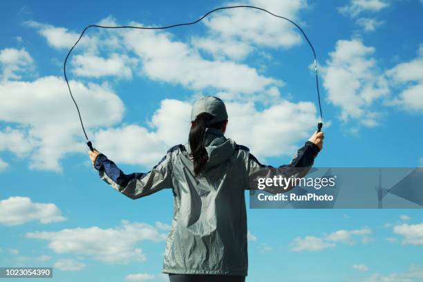 woman skipping  rope outdoors - 縄跳びの縄 ストックフォトと画像