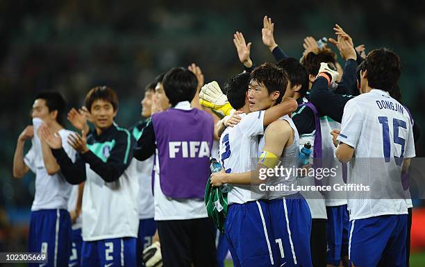 The South Korea team celebrates after a draw gives them victory and progress to round two in the 2010 FIFA World Cup South Africa Group B match...