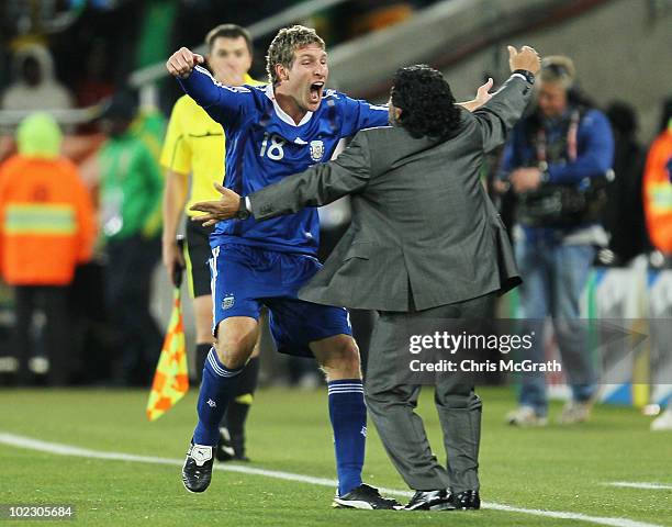 Diego Maradona head coach of Argentina celebrates with goalscorer Martin Palermo after the 2010 FIFA World Cup South Africa Group B match between...