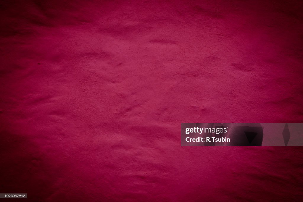 Red background wall texture with dark edges